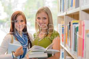 Girl friends studying books together in library
