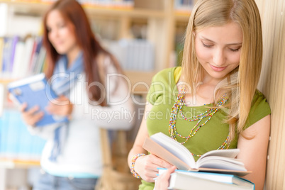 Teenage student read book at high school library