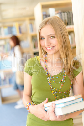 Teenage student with book at high school library