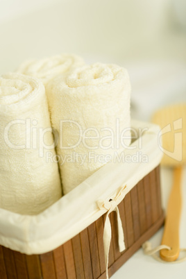 Bathroom towels folded in wooden basket