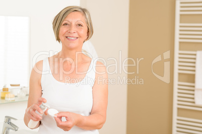 Senior woman smiling in bathroom morning hygiene