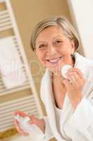 Senior woman hold cotton pad make-up removal