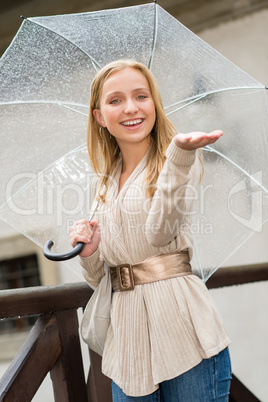 Young happy woman in rain with umbrella