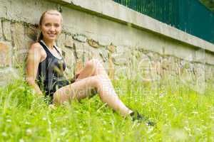Young sportive woman relax in grass workout