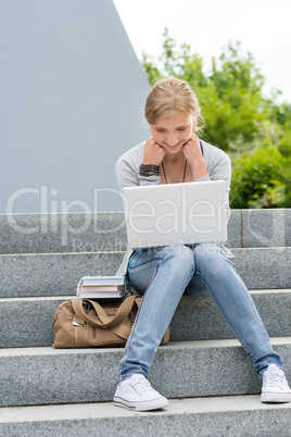 Young student woman outdoor with laptop