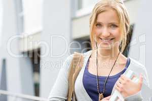 Young happy woman holding books to school