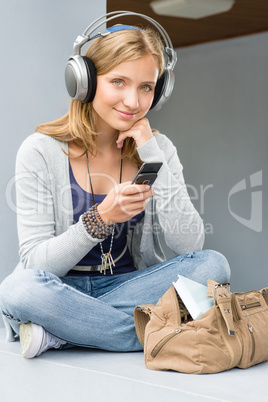 Teenage woman holding her mobile phone