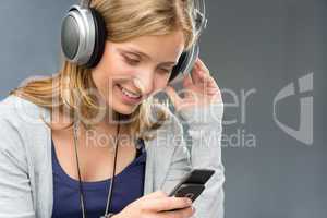 Young woman with headphones checking mobile phone