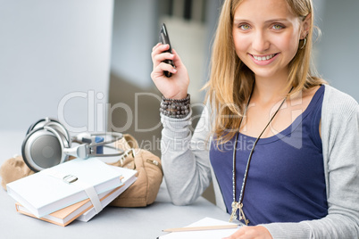 Student woman with notes and cellphone