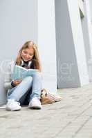 Smiling young study woman read book outdoor