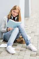 Student reading book outside of school young