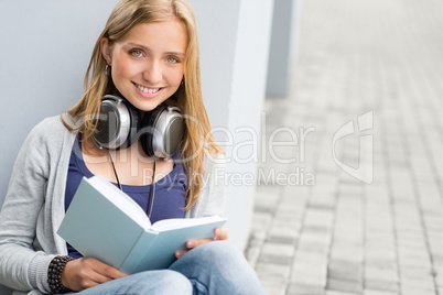 Woman reading book outside of school young