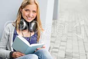 Woman reading book outside of school young