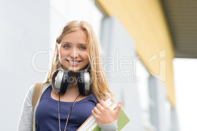 Student girl with headphones smiling at camera