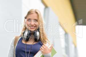 Student girl with headphones smiling at camera