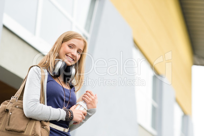 Student carrying books to school headphones young