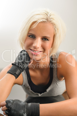 Female kickboxer in black relax lying down