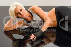 Woman kickboxer in black relax on floor