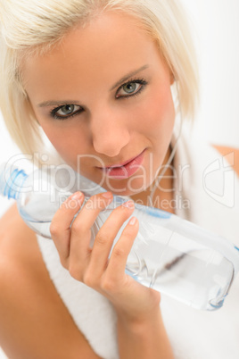 Attractive blond fitness woman with water bottle