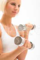 Woman exercise dumbbells white fitness close-up