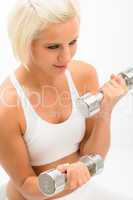 Fitness woman lifting dumbbells exercise on white