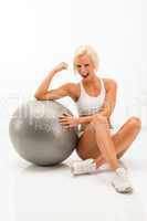 Successful fitness woman with exercise ball white