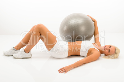 Slim blond woman exercise with fitness ball