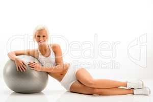 Woman in white fitness outfit exercise ball