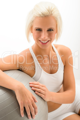 Woman with fitness ball posing on white