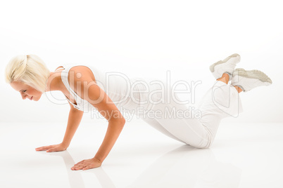 Woman exercise pushup at white fitness outfit
