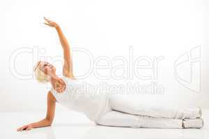 White fitness woman stretch body at Pilates.