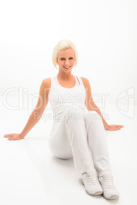 Fitness woman resting on white floor