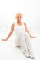 Fitness woman resting on white floor