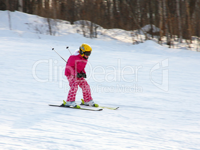 Little girl skiing downhill