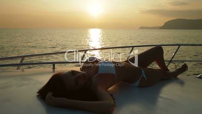 Female Silhouette on Yacht at Sunset