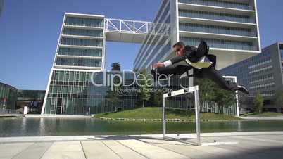 slow motion business man over hurdle