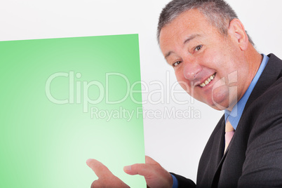 Man holding and pointing at blank green sign