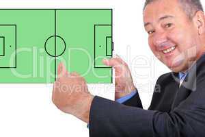 Man pointing at sign with football field