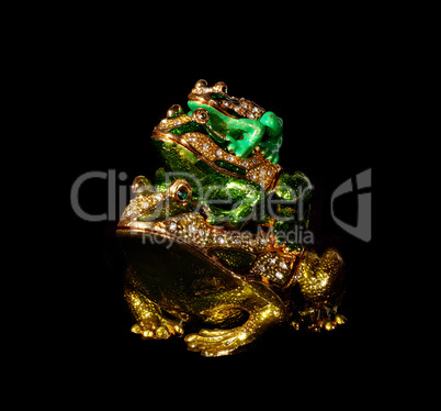 Metal toad with crystals on the black background (souvenir)