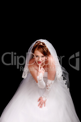 Redhead bride in a white dress with a black background