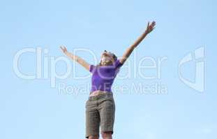 Young woman sitting with raised hand