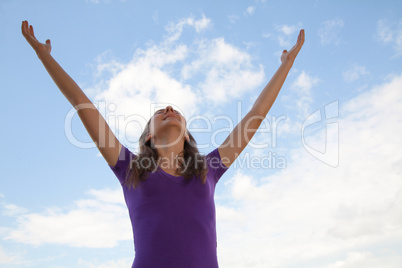 Young woman standing with raised hand