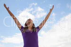 Young woman standing with raised hand