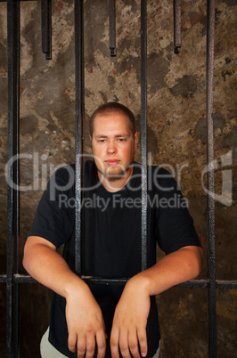 Young man behind the bars