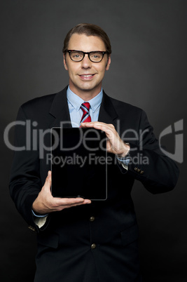 Portrait of businessman showing new digital device