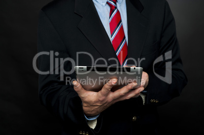 Cropped image of businessman browsing tablet pc