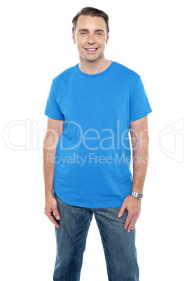 Cheerful calm male model posing in trendy casuals