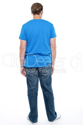 Rear view of casual young guy posing