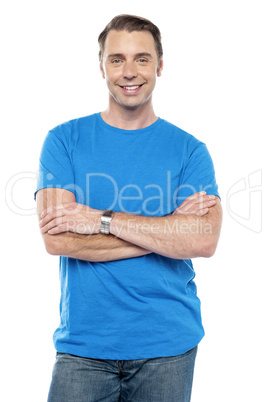 Smart young guy posing with arms crossed