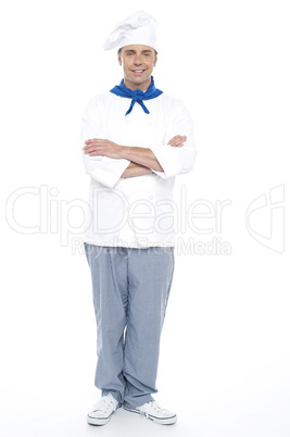 Young chef posing with his arms crossed